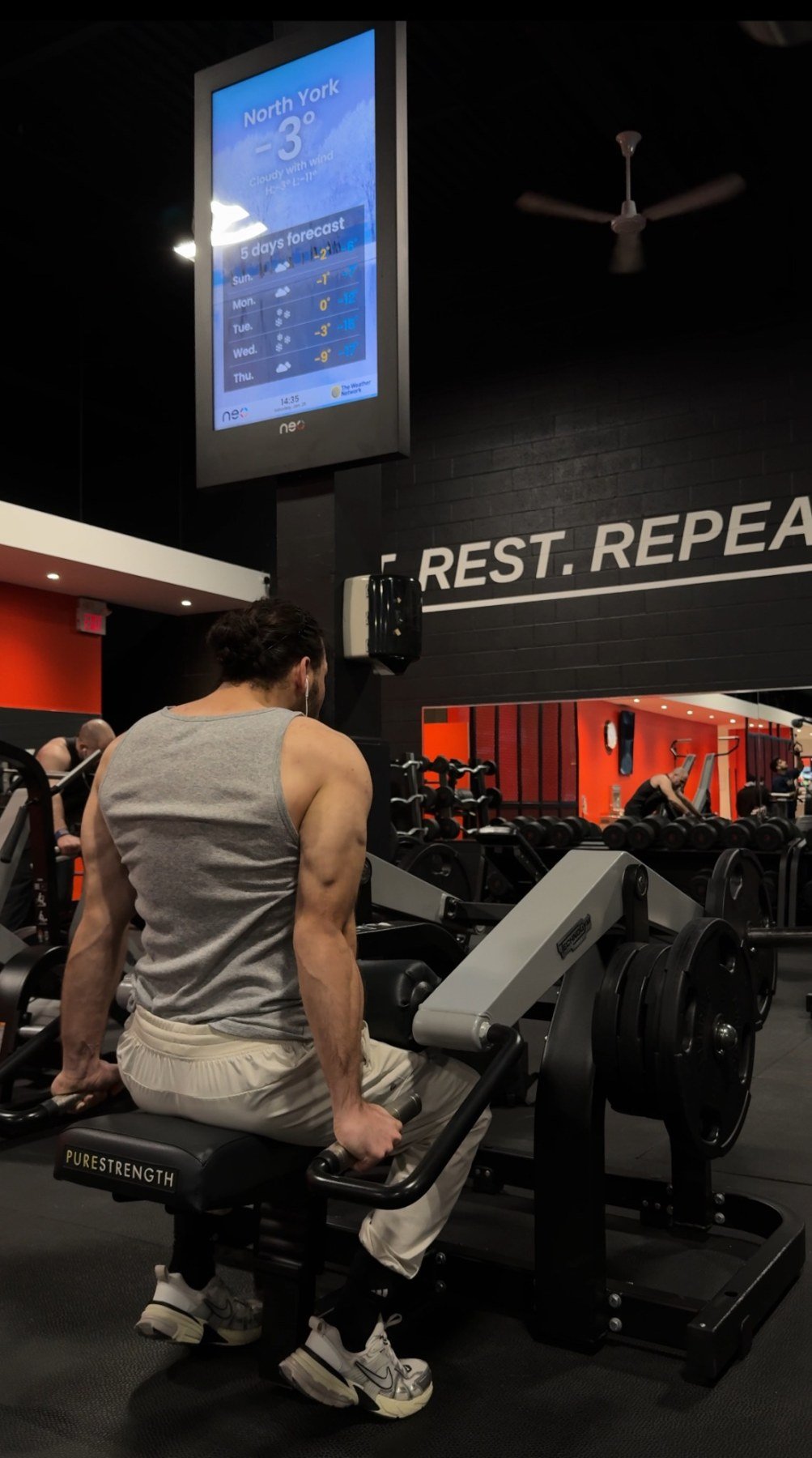 Musavir strength training in a gym, viewed from behind